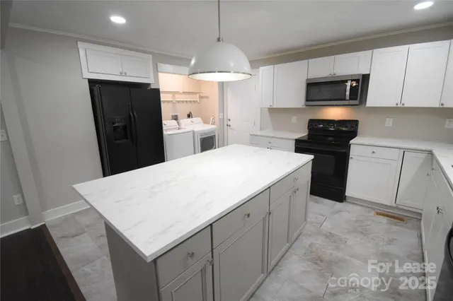 a kitchen with a sink a refrigerator a stove a microwave and cabinets