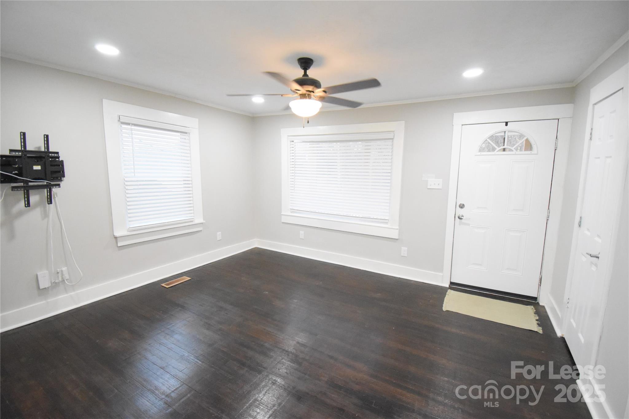 199 Crowell Drive Southwest Concord, NC 28025 - Photo 8 of 19 a view of an empty room with a window and wooden floor