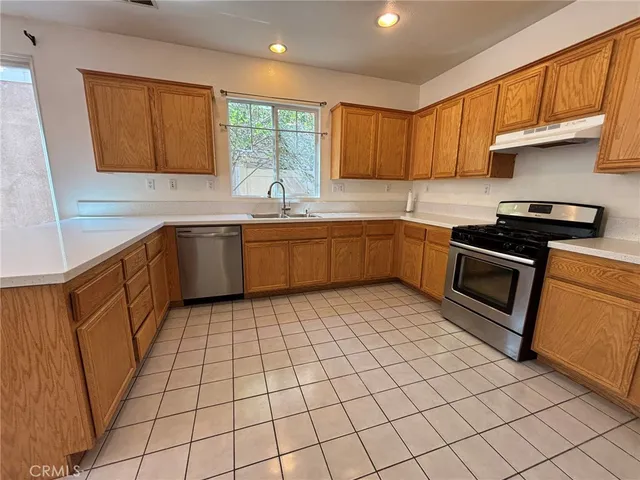 a kitchen with stainless steel appliances granite countertop a sink and cabinets