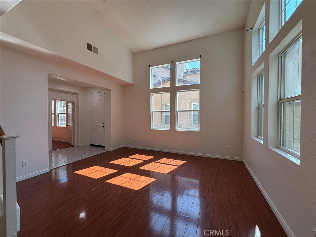 1890 Flint Court Riverside, CA 92501 - Photo 5 of 25 a view of an empty room with window and wooden floor