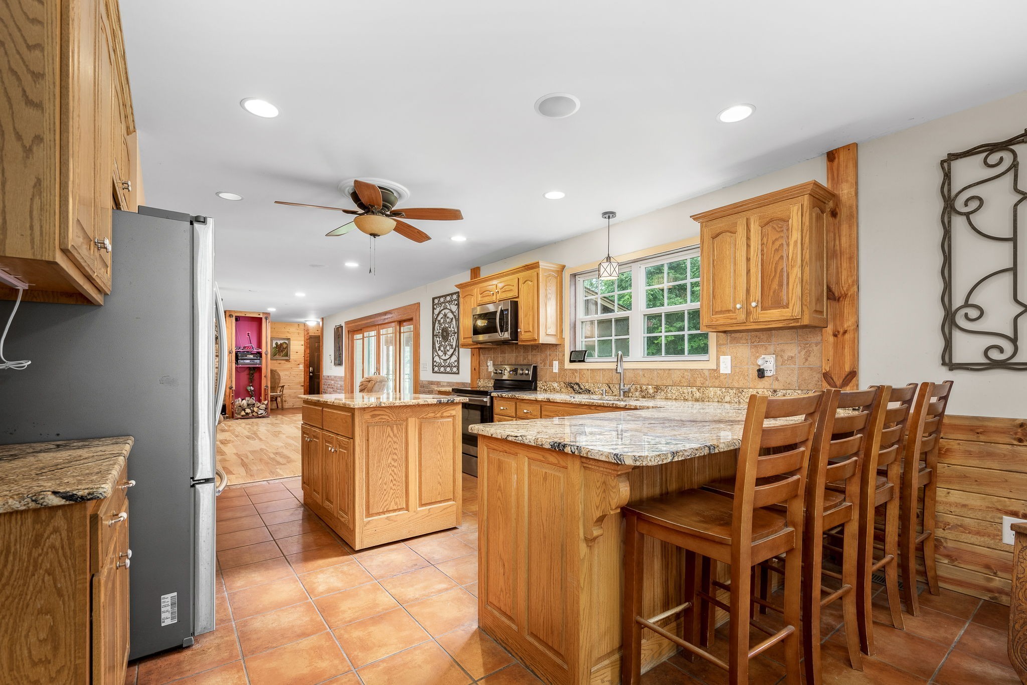 745 Union Ridge Road Wartrace, TN 37183 - Photo 16 of 76 a kitchen with stainless steel appliances kitchen island granite countertop a table chairs and a refrigerator