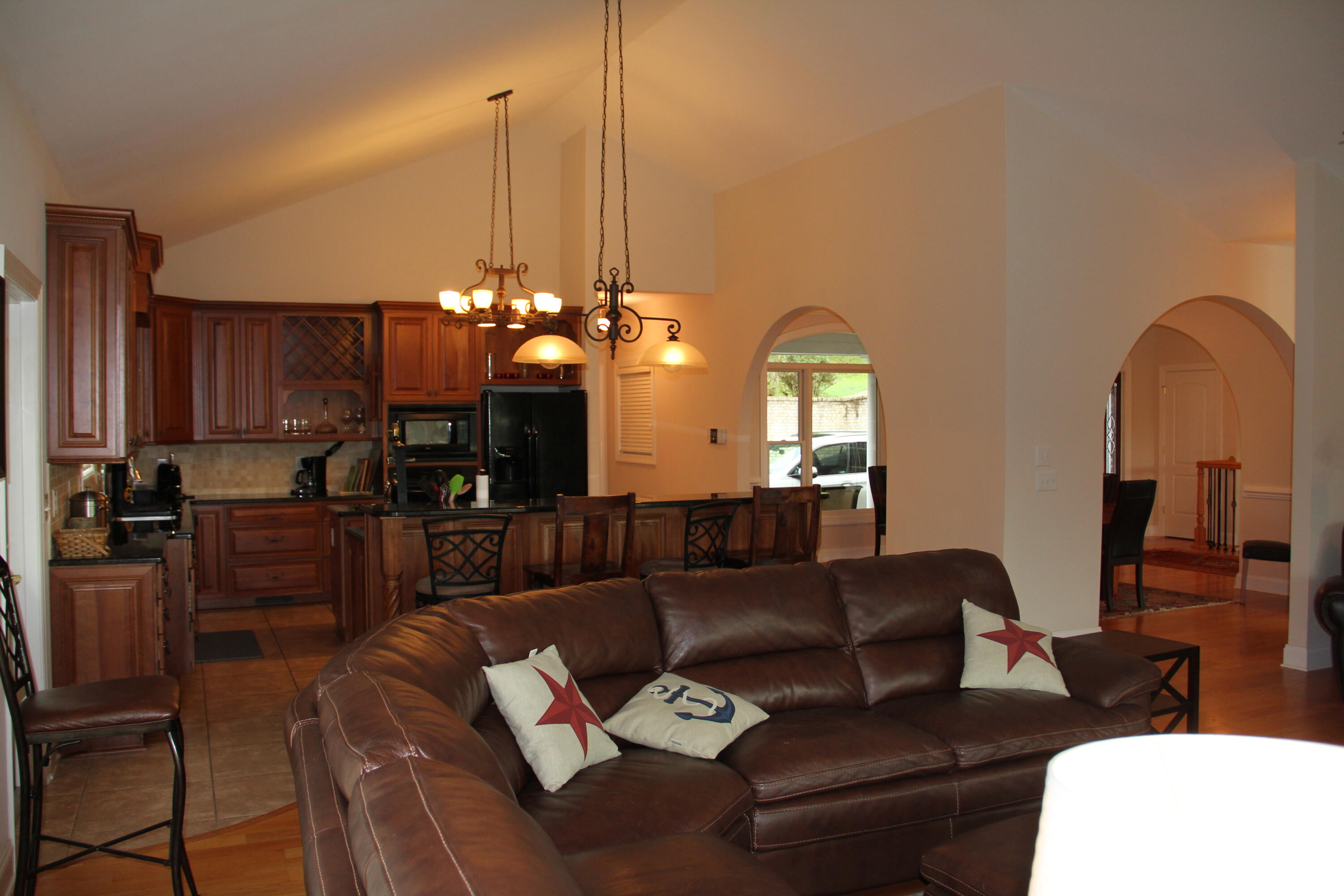 4 Calypso Road Moneta, VA 24121 - Photo 15 of 78 a living room with furniture a chandelier and kitchen view