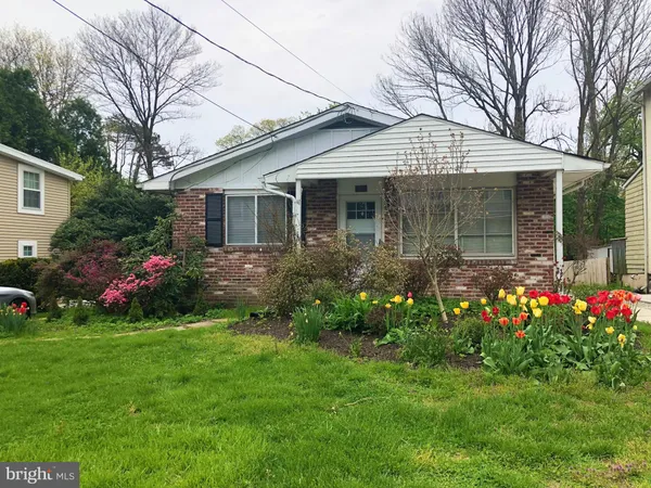 a front view of house with a garden