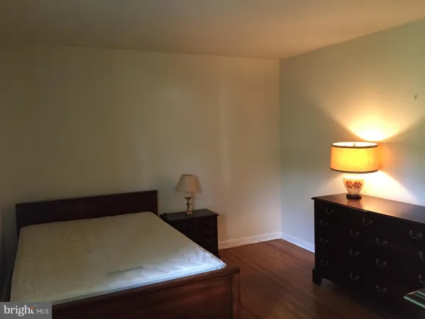 a bedroom with a bed and lamps
