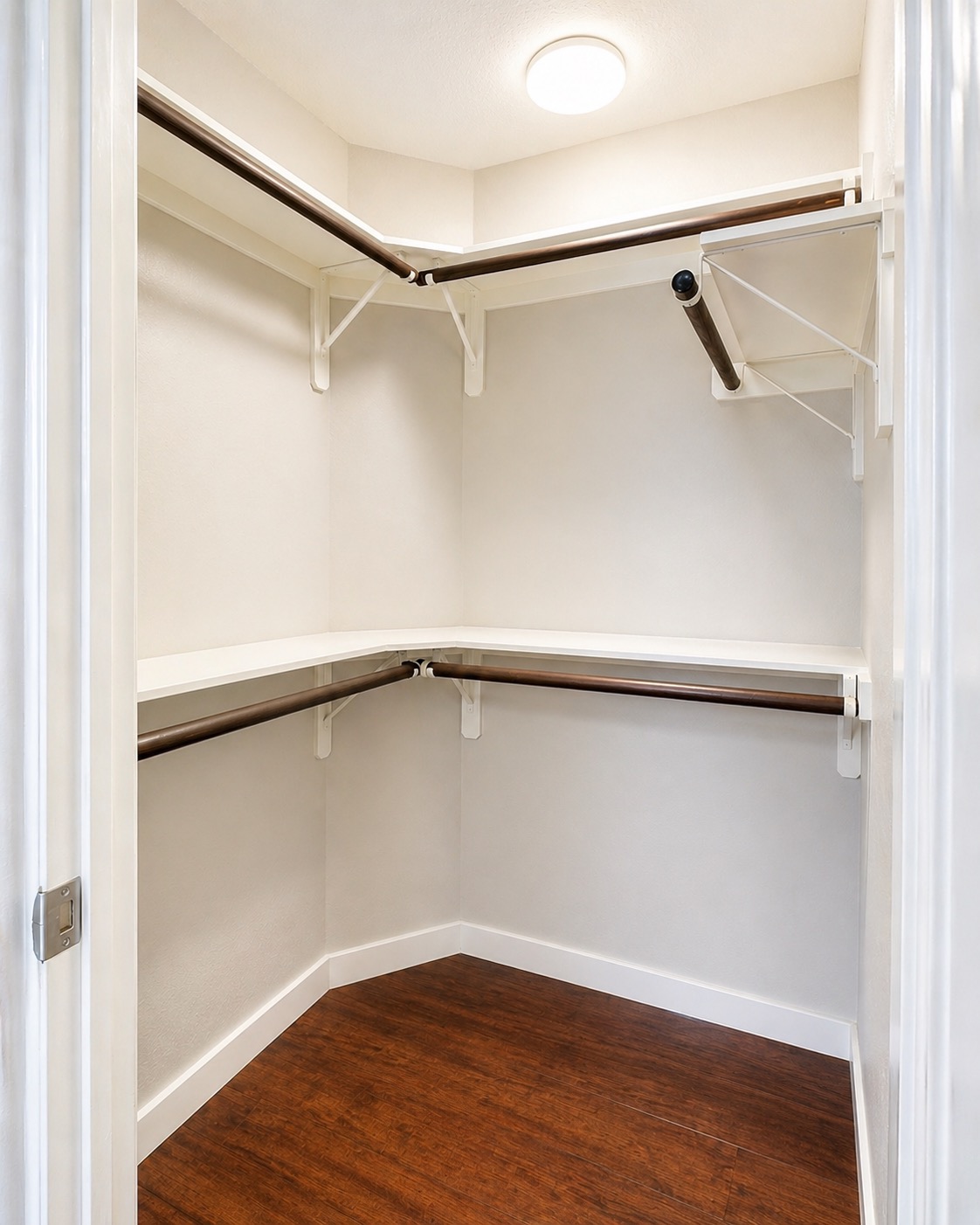 1748 Ohlen Road, Unit 22 Austin, TX 78757 - Photo 7 of 14 Walk-in closet featuring wood-finish flooring, and hanging rods