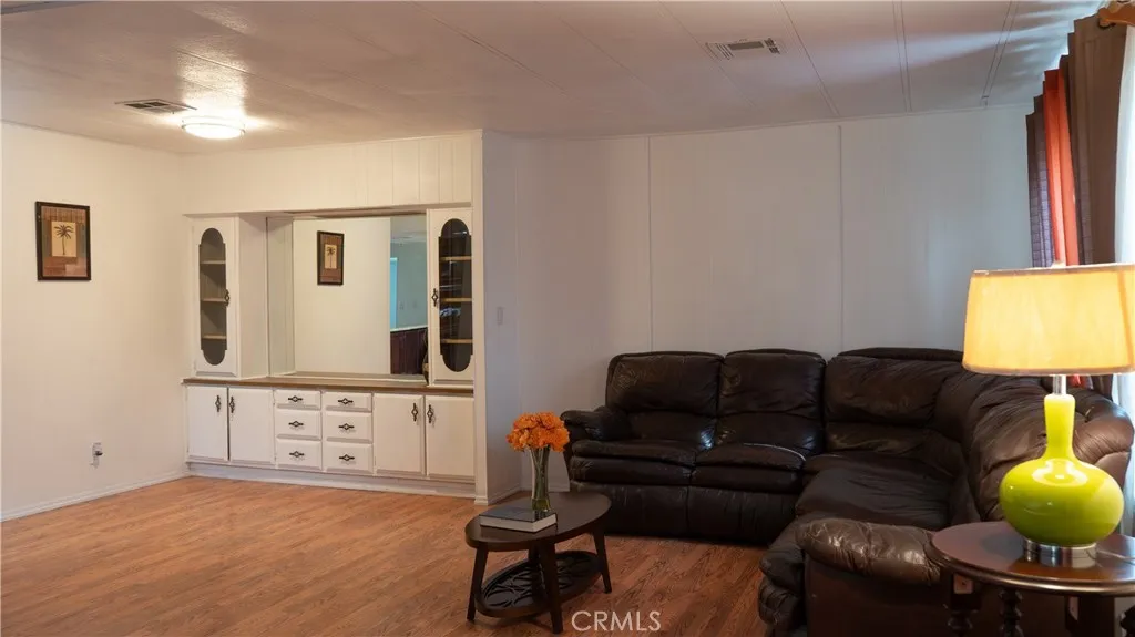 250 North Linden Avenue, Unit 248 Rialto, CA 92376 - Photo 7 of 13 a living room with furniture and a lamp