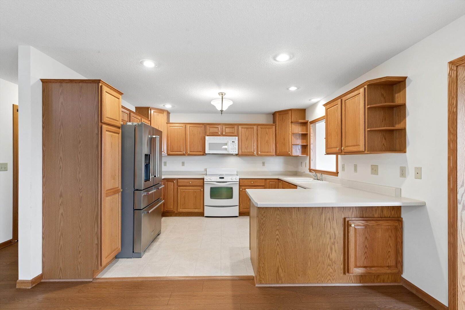 118 5th Street, Unit 2 Fulton, IL 61252 - Photo 12 of 54 a kitchen with stainless steel appliances granite countertop a sink stove and refrigerator