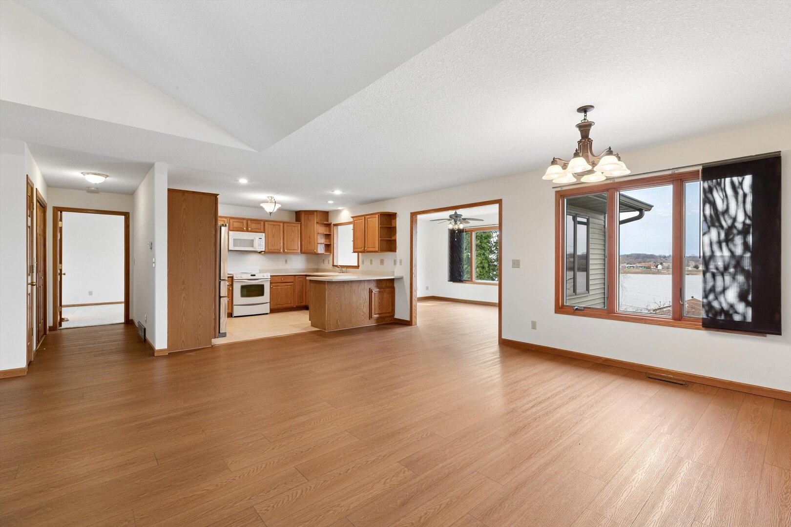 118 5th Street, Unit 2 Fulton, IL 61252 - Photo 8 of 54 a view of an empty room with wooden floor and a kitchen