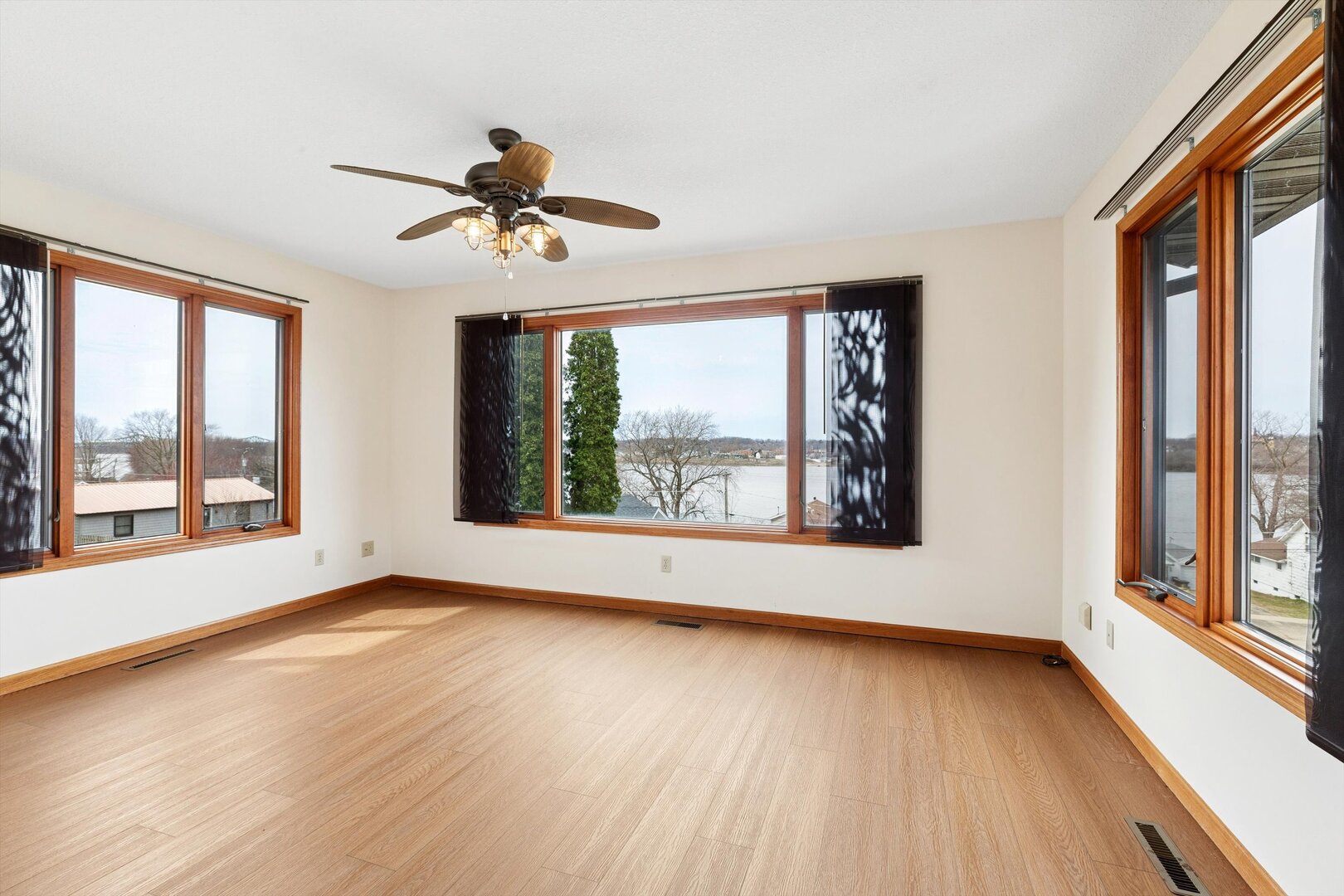 118 5th Street, Unit 2 Fulton, IL 61252 - Photo 10 of 54 a view of an empty room with wooden floor and a window