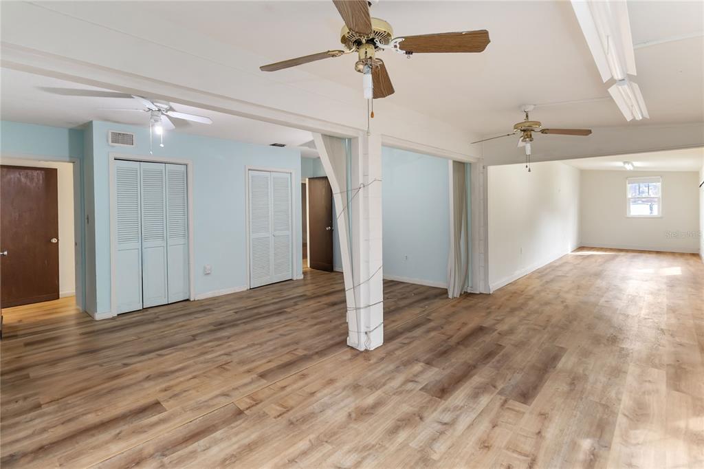 1730 Neptune Road Kissimmee, FL 34744 - Photo 13 of 38 a view of a livingroom with wooden floor and a ceiling fan