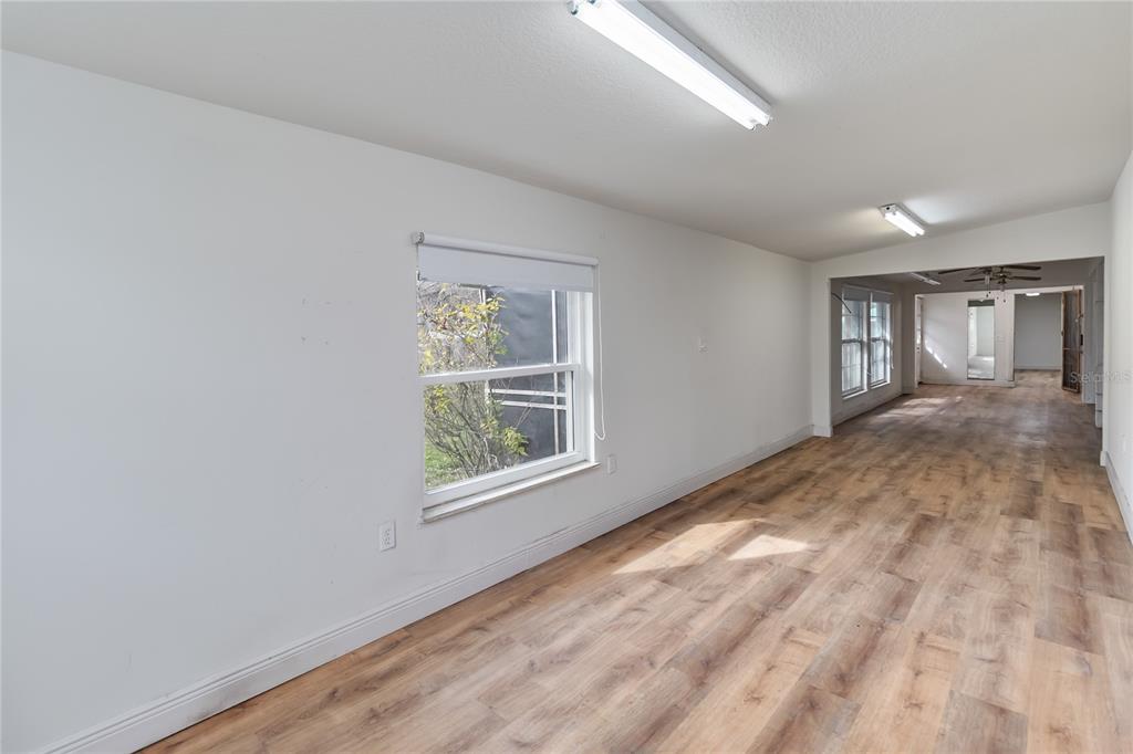 1730 Neptune Road Kissimmee, FL 34744 - Photo 14 of 38 an empty room with wooden floor and windows