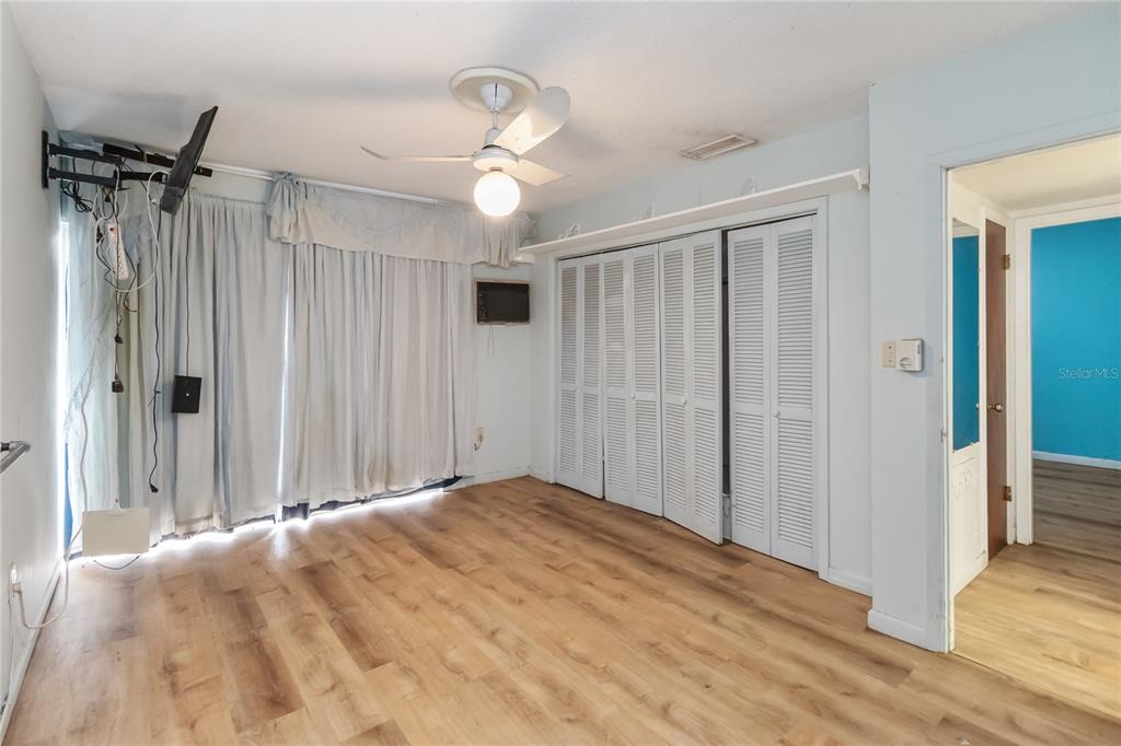 1730 Neptune Road Kissimmee, FL 34744 - Photo 15 of 38 a view of a livingroom with a chandelier fan and wooden floor