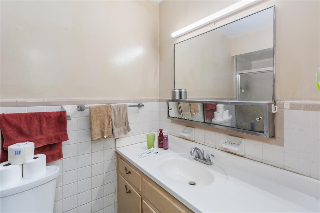 1730 Neptune Road Kissimmee, FL 34744 - Photo 19 of 38 a bathroom with a sink and a mirror