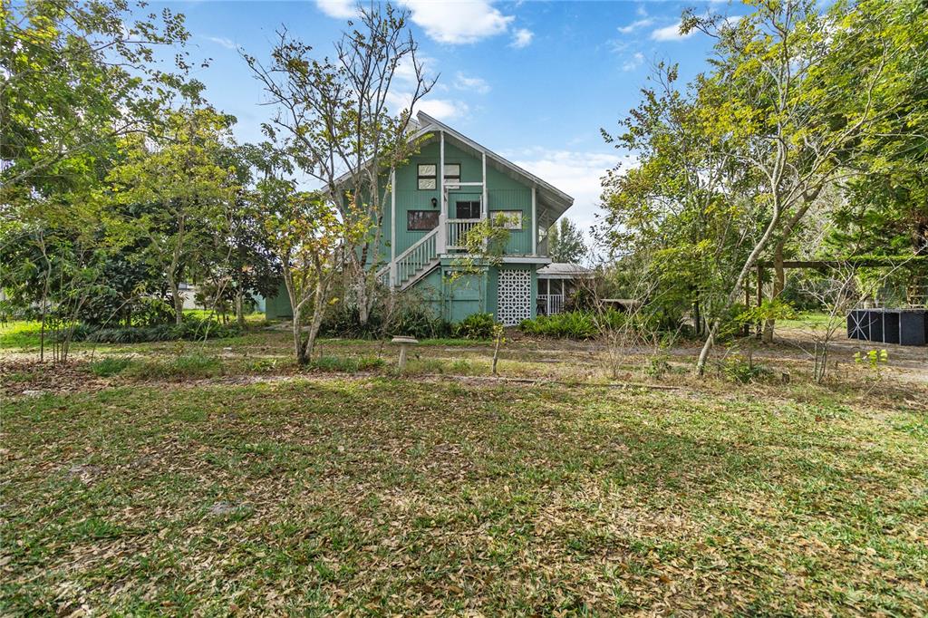 1730 Neptune Road Kissimmee, FL 34744 - Photo 2 of 38 a front view of a house with a yard