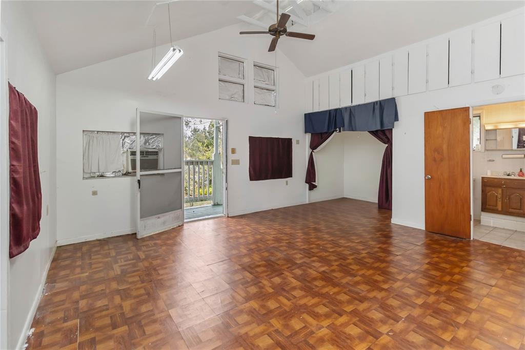 1730 Neptune Road Kissimmee, FL 34744 - Photo 26 of 38 a view of a kitchen with wooden cabinet and a refrigerator