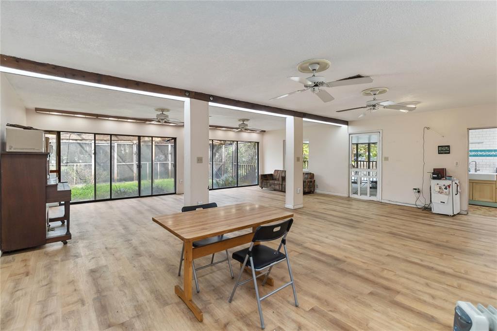 1730 Neptune Road Kissimmee, FL 34744 - Photo 8 of 38 a workspace with wooden floor and sliding door