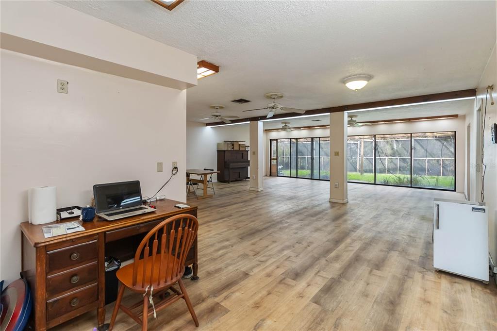 1730 Neptune Road Kissimmee, FL 34744 - Photo 9 of 38 a view of a workspace with furniture and wooden floor