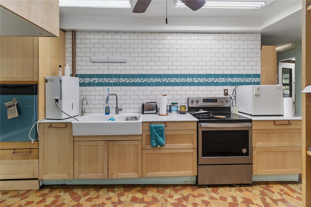 1730 Neptune Road Kissimmee, FL 34744 - Photo 10 of 38 a kitchen with granite countertop a sink and a stove