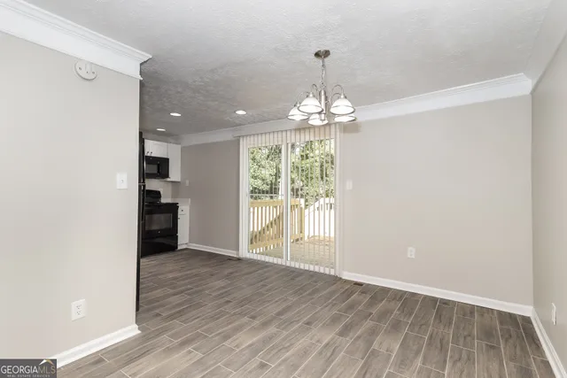a view of livingroom with kitchen and hardwood