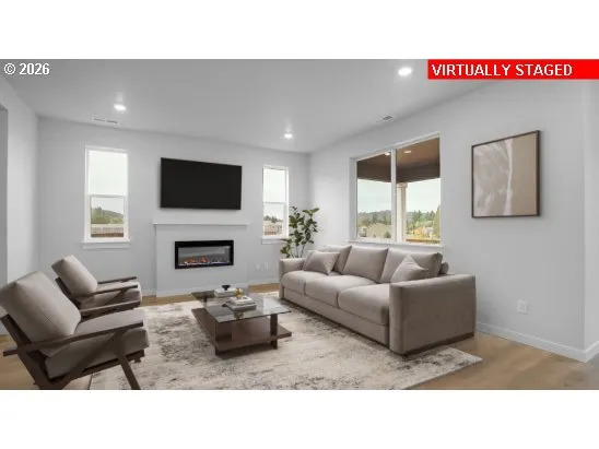 a living room with a bed and a potted plant