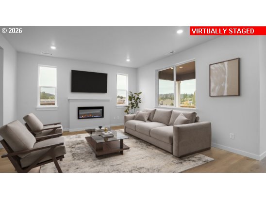 3650 Southwest 37th Street Gresham, OR 97080 - Photo 5 of 8 a living room with furniture a fireplace and a flat screen tv