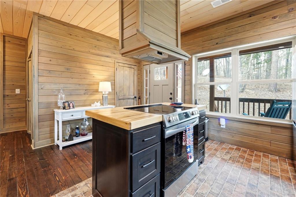 1041 Astro Court Northeast Ranger, GA 30734 - Photo 14 of 52 a kitchen with a stove and a wooden floor