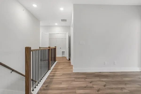 a view of a hallway with wooden floor