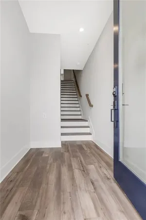 a view of an empty room with wooden floor