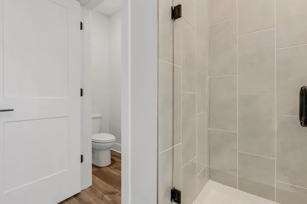 a bathroom with a toilet and a shower