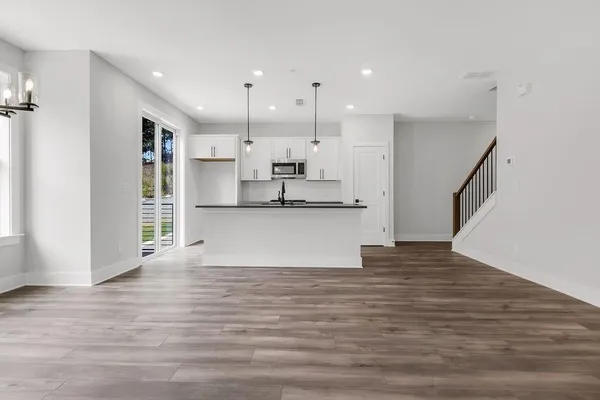 a view of kitchen with wooden floor and electronic appliances