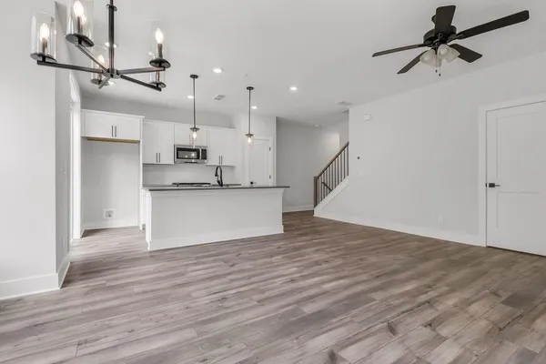 a view of a kitchen with wooden floor and a sink