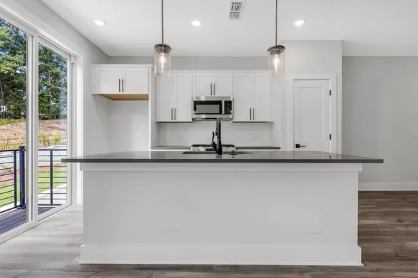 a kitchen with stainless steel appliances granite countertop a refrigerator a sink and a stove