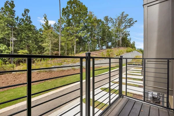 a view of a balcony with wooden floor and outdoor space