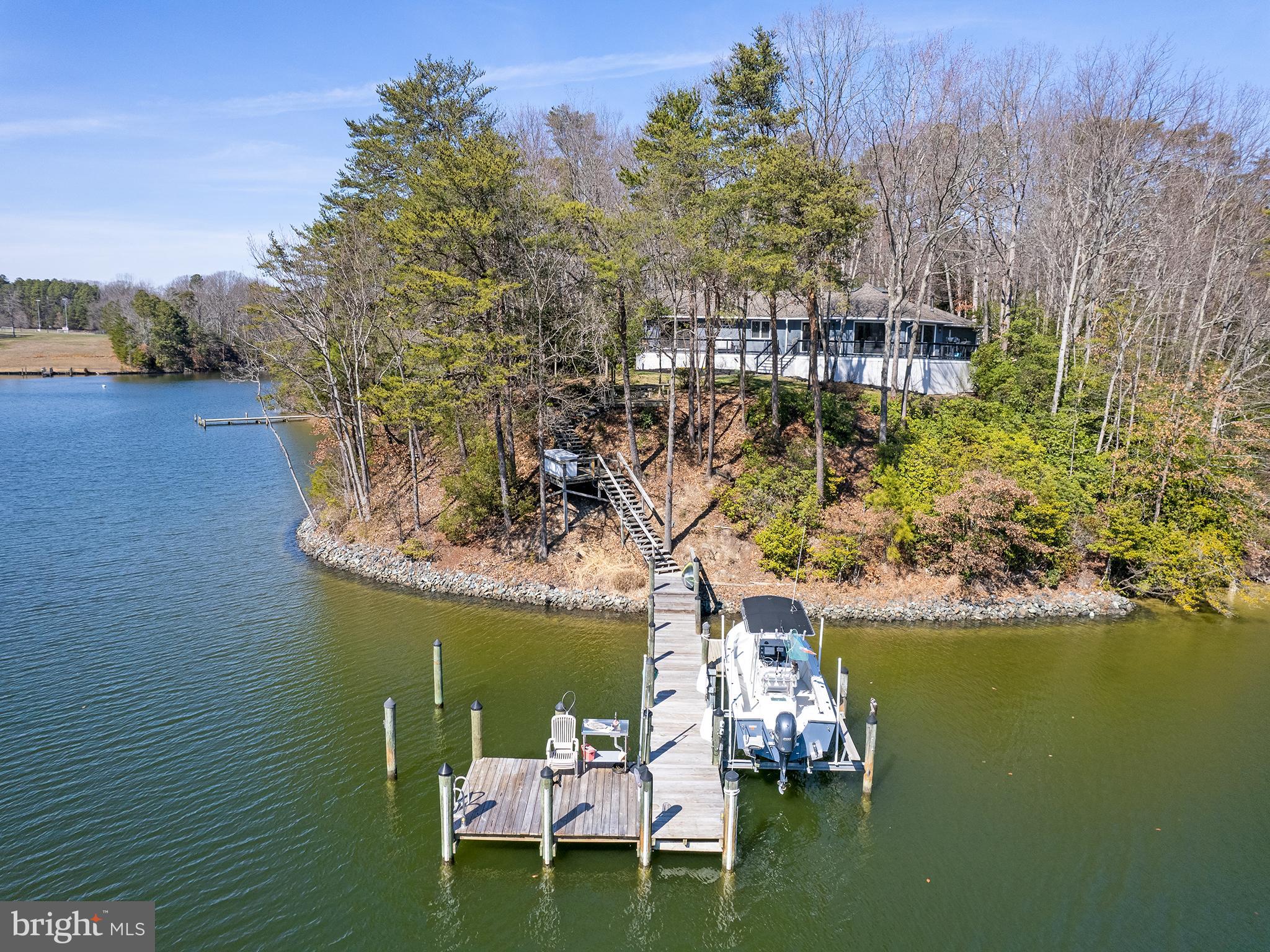 855 Big Road Lusby, MD 20657 - Photo 3 of 48 a view of a lake with chairs