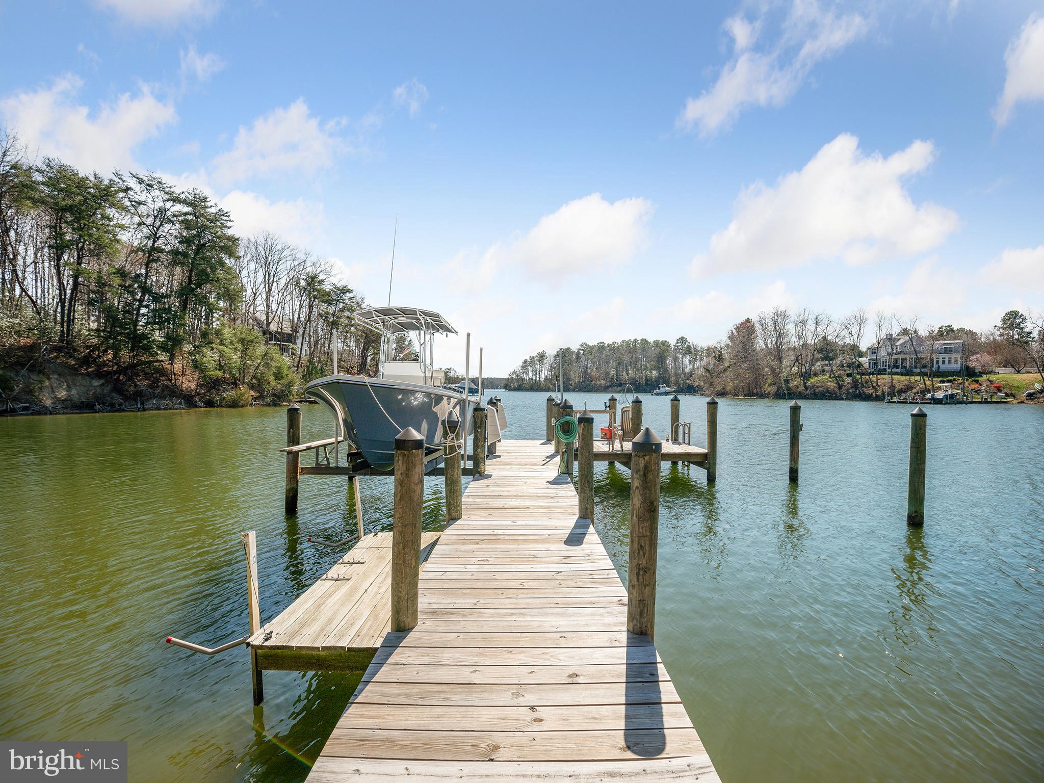 855 Big Road Lusby, MD 20657 - Photo 40 of 48 a view of a lake with boats and trees in the background