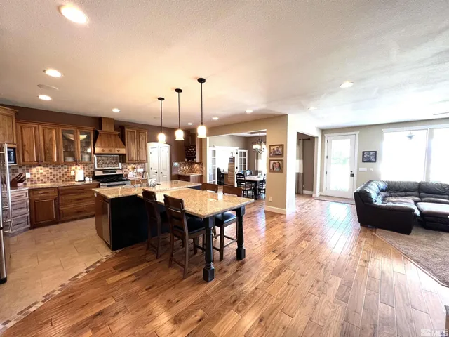 a view of kitchen with granite countertop cabinets and wooden floor