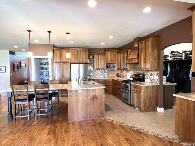 a kitchen with lots of counter top space and stainless steel appliances