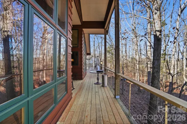 a view of a balcony with wooden floor and stairs