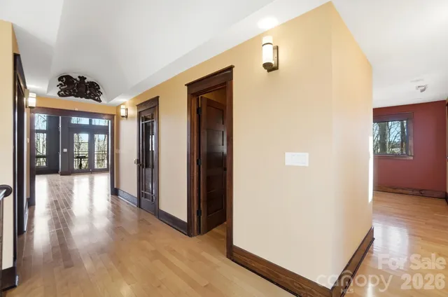a view of a hallway with wooden floor and entryway