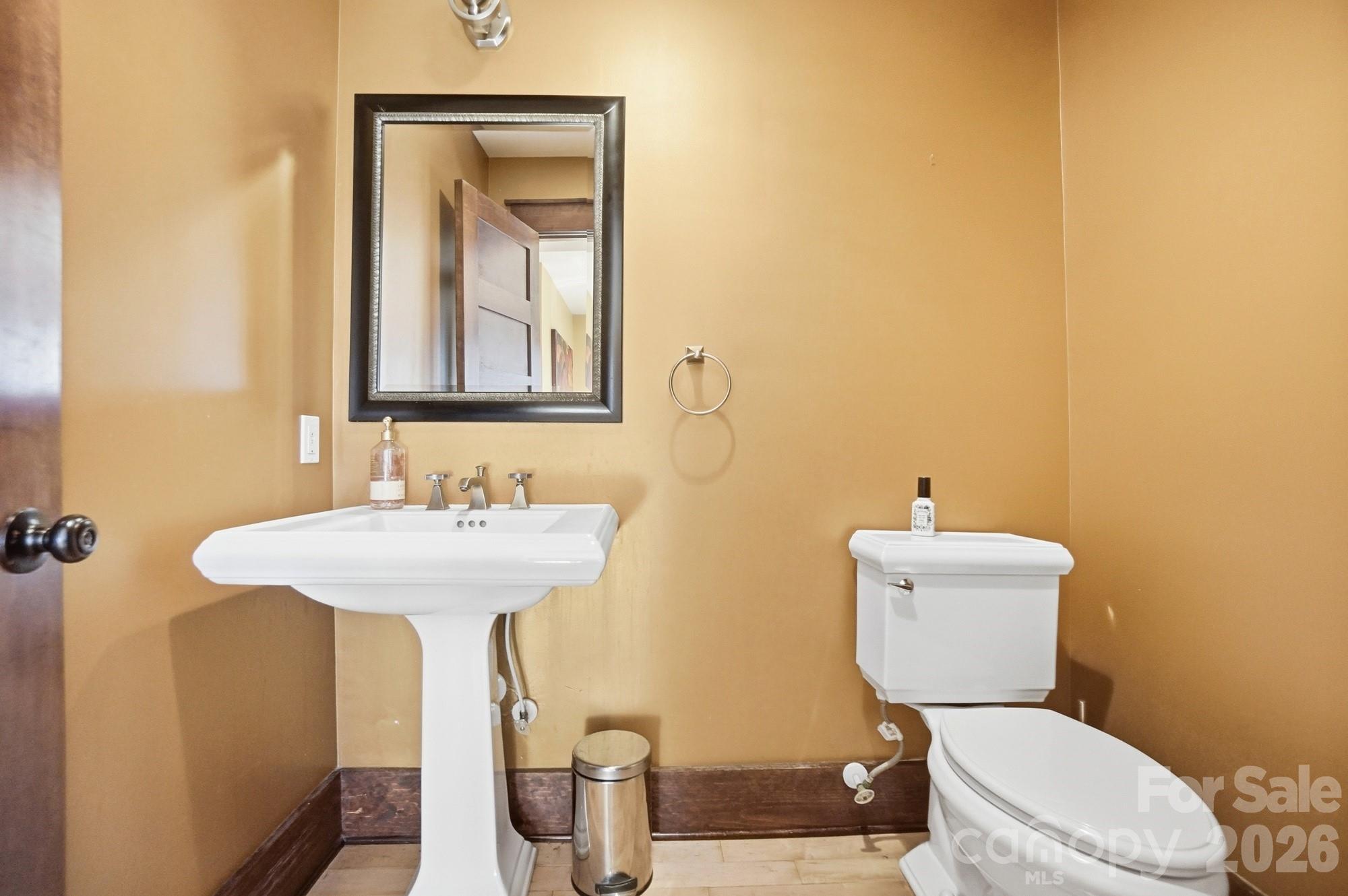 17928 Pages Pond Court Davidson, NC 28036 - Photo 20 of 48 a bathroom with a toilet sink and mirror