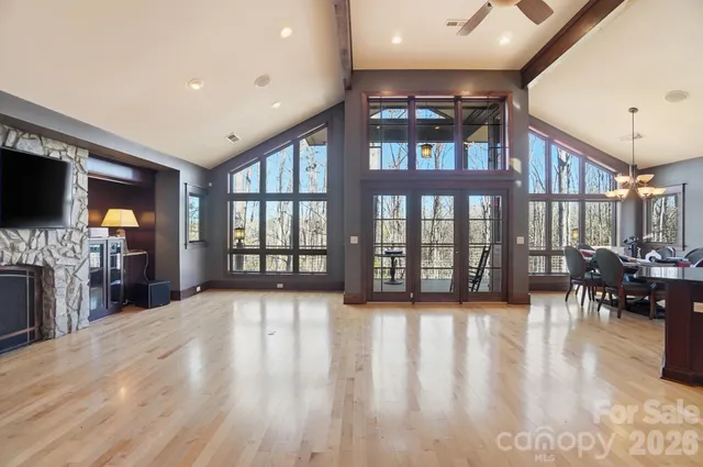 a view of an empty room with a fireplace and a window