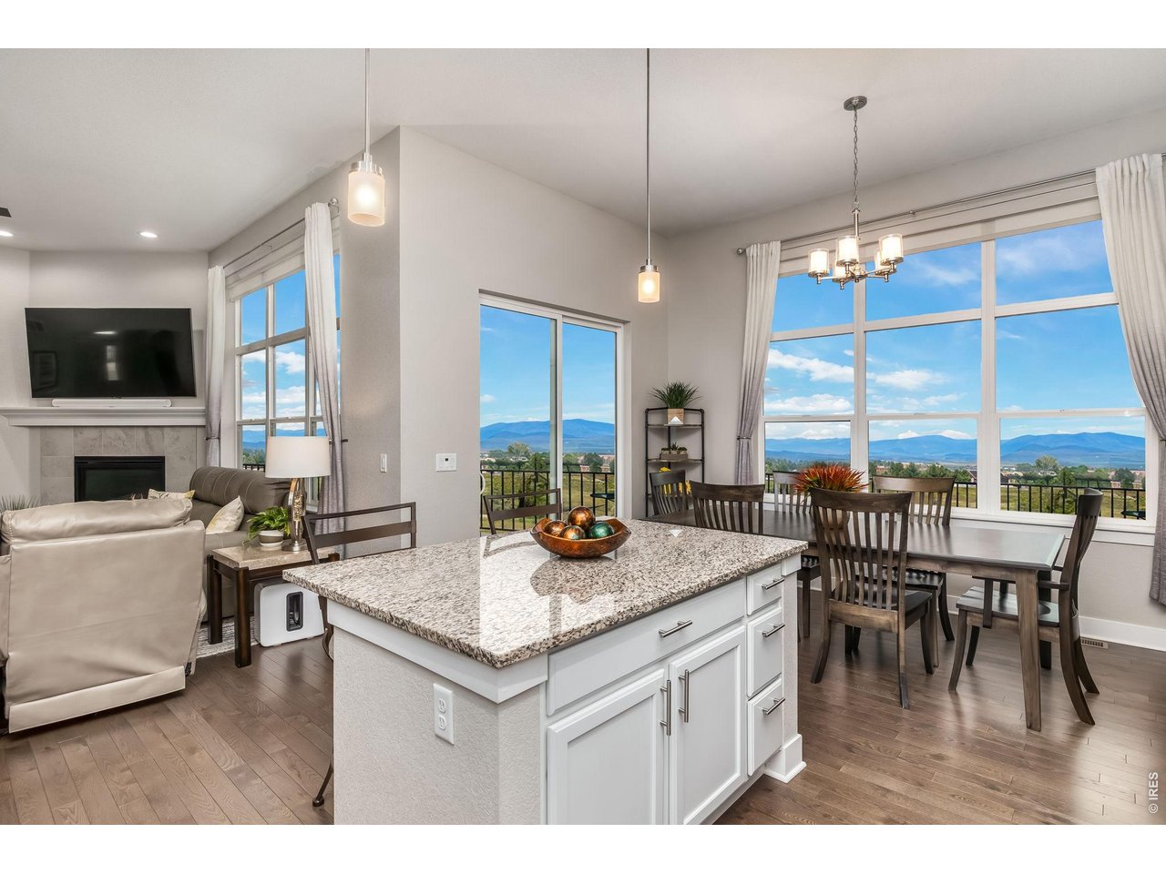 3789 Bridle Ridge Circle Severance, CO 80524 - Photo 11 of 44 a kitchen with a stove a kitchen island a dining table and chairs