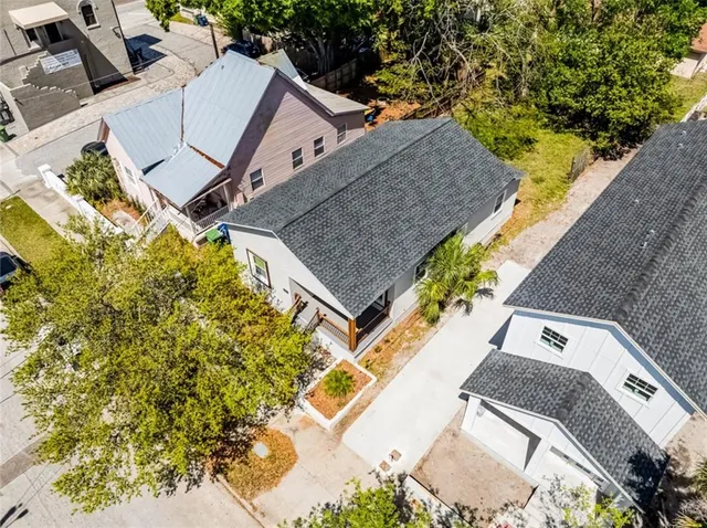 an aerial view of a house with a yard