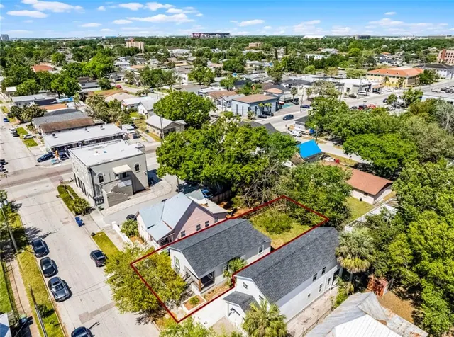 an aerial view of a house with a yard