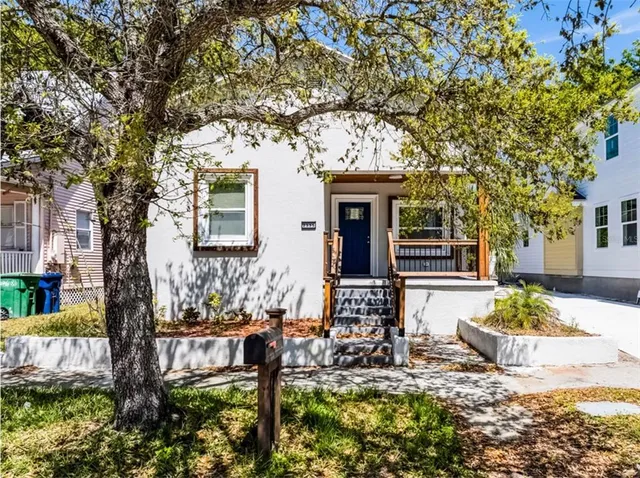 a front view of a house with sitting area