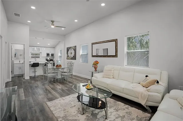 a living room with furniture and kitchen view