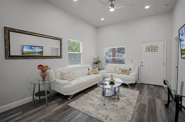 a living room with furniture and wooden floor