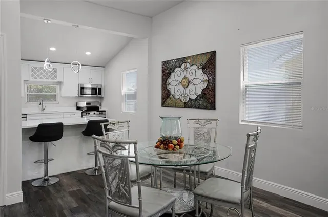 a view of a dining room with furniture and wooden floor