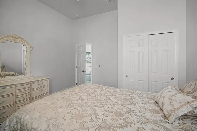 a bedroom with a bed and a mirror