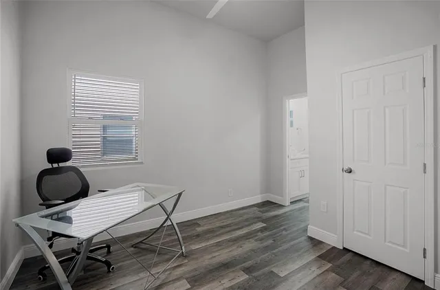 a room with wooden floor and white walls